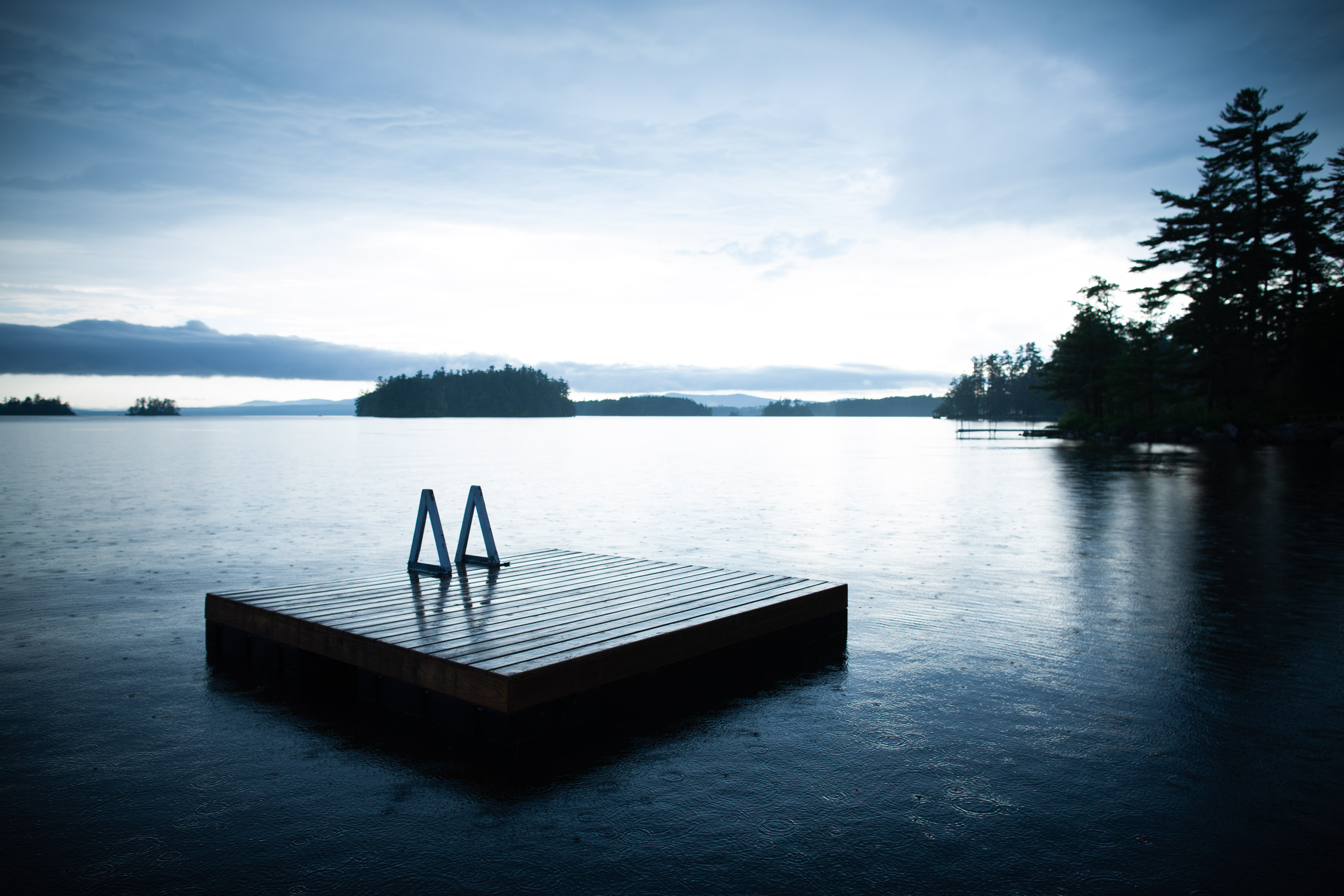Floating dock on a lake in a rain shower